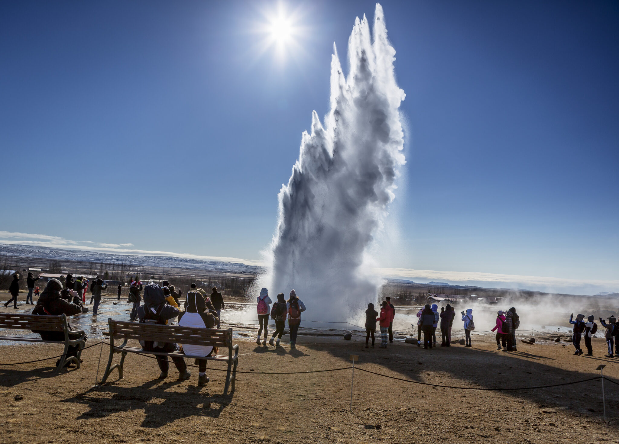 Luxury travellers at Icelandic geyser
